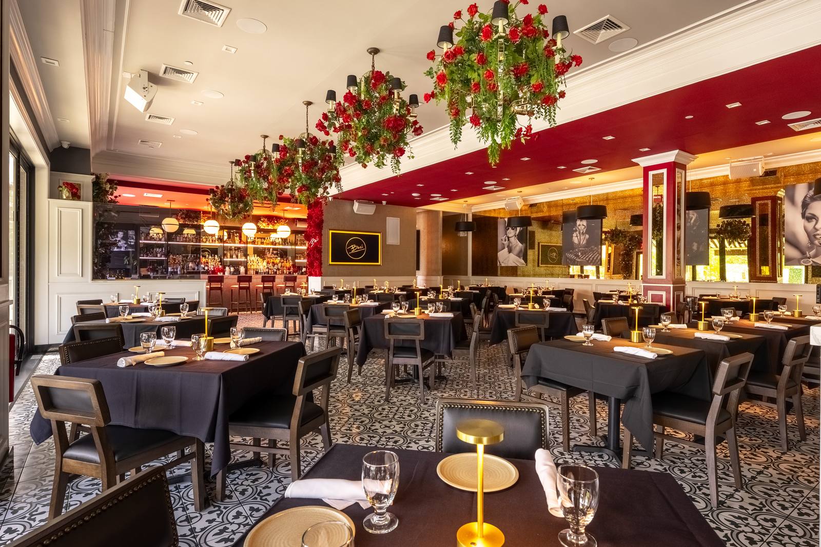 The main dining room with rose chandeliers and patterned tile floors